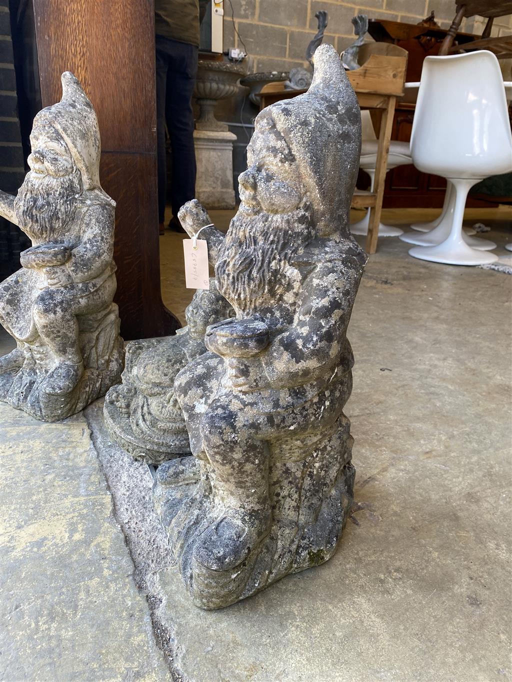 A pair of reconstituted stone garden gnomes, height 62cm together with a seated Buddha